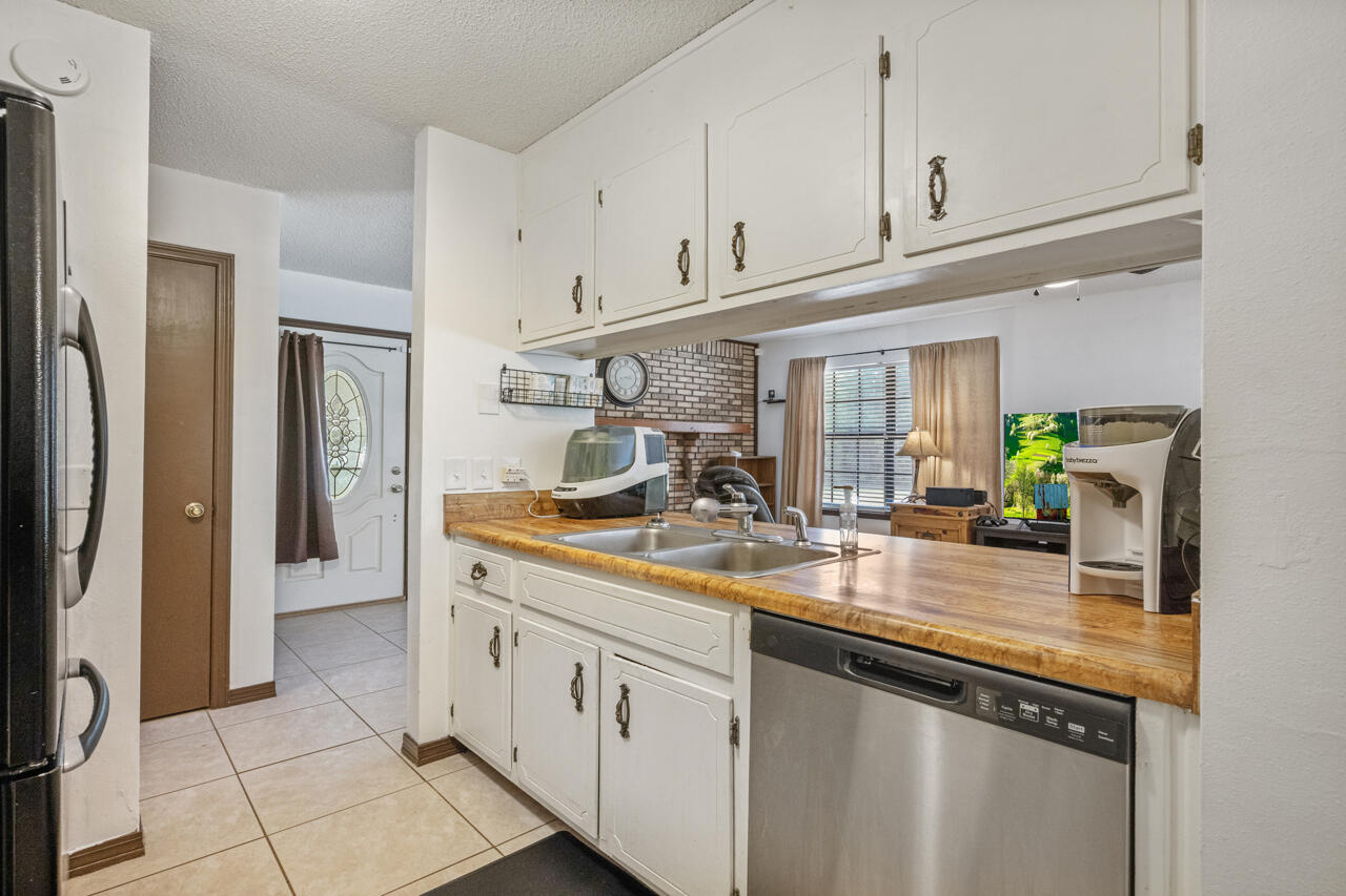 7151 Wallace Drive Pace, FL 32571 - Photo 13 of 40 a kitchen with stainless steel appliances granite countertop a sink and cabinets