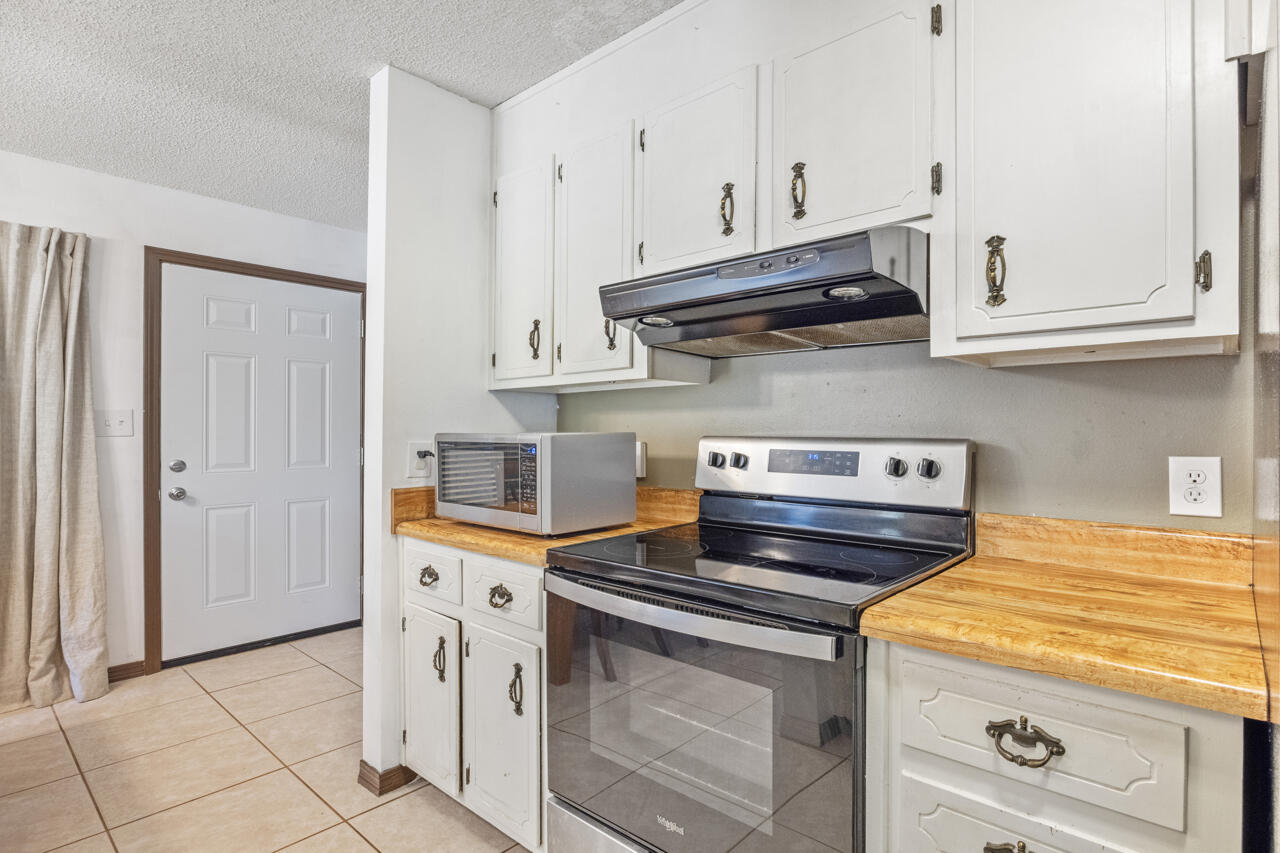 7151 Wallace Drive Pace, FL 32571 - Photo 14 of 40 a kitchen with stainless steel appliances granite countertop a sink and a stove