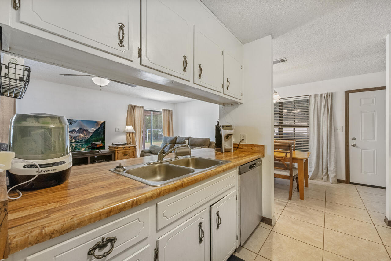 7151 Wallace Drive Pace, FL 32571 - Photo 15 of 40 a kitchen with a sink and cabinets