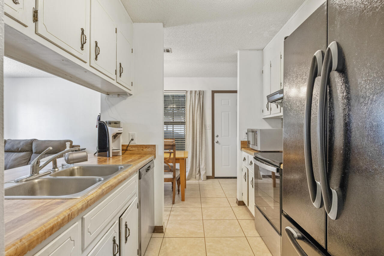 7151 Wallace Drive Pace, FL 32571 - Photo 16 of 40 a kitchen with stainless steel appliances a refrigerator sink and cabinets