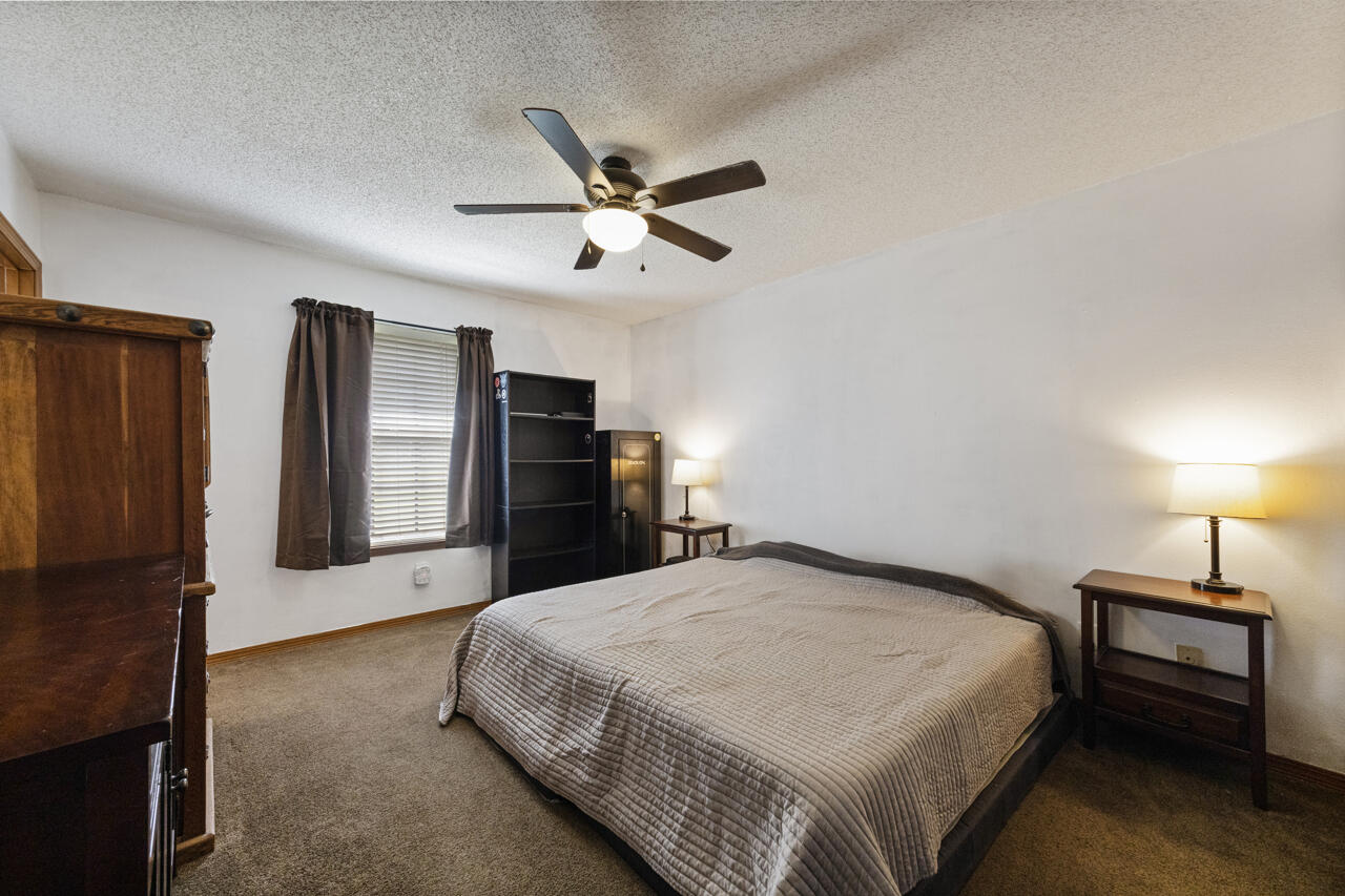 7151 Wallace Drive Pace, FL 32571 - Photo 17 of 40 a spacious bedroom with a bed and a chandelier