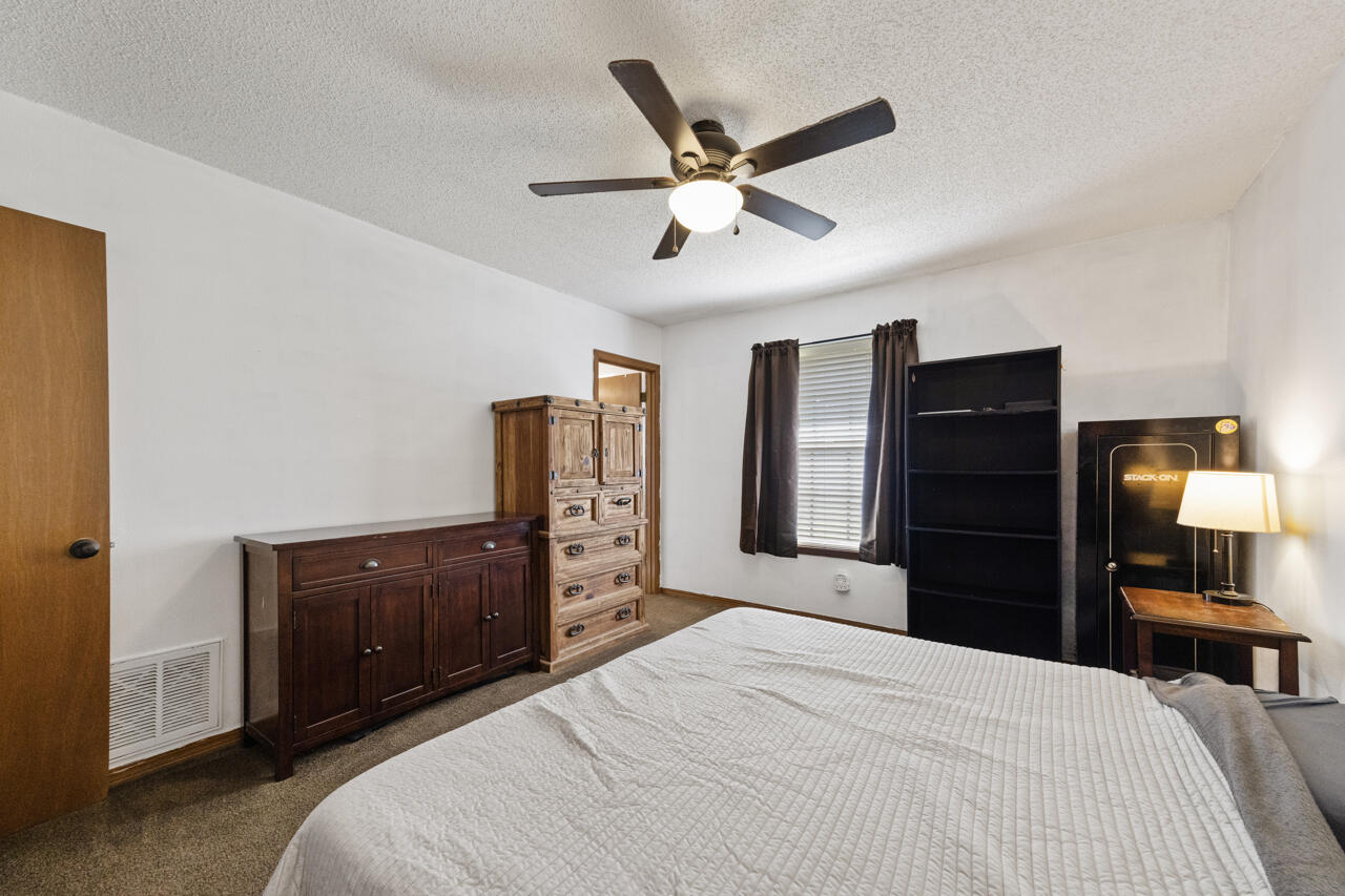 7151 Wallace Drive Pace, FL 32571 - Photo 18 of 40 a bedroom with a bed and a large mirror