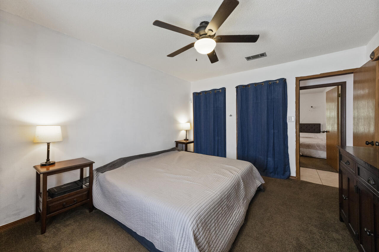 7151 Wallace Drive Pace, FL 32571 - Photo 19 of 40 a bedroom with a bed and a chandelier