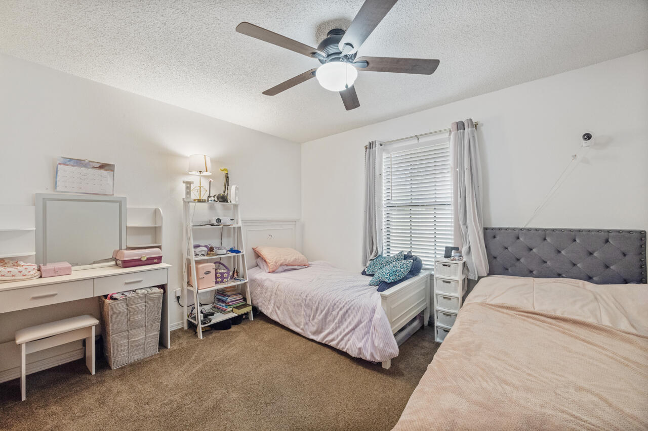 7151 Wallace Drive Pace, FL 32571 - Photo 21 of 40 a bedroom with a bed and a chandelier