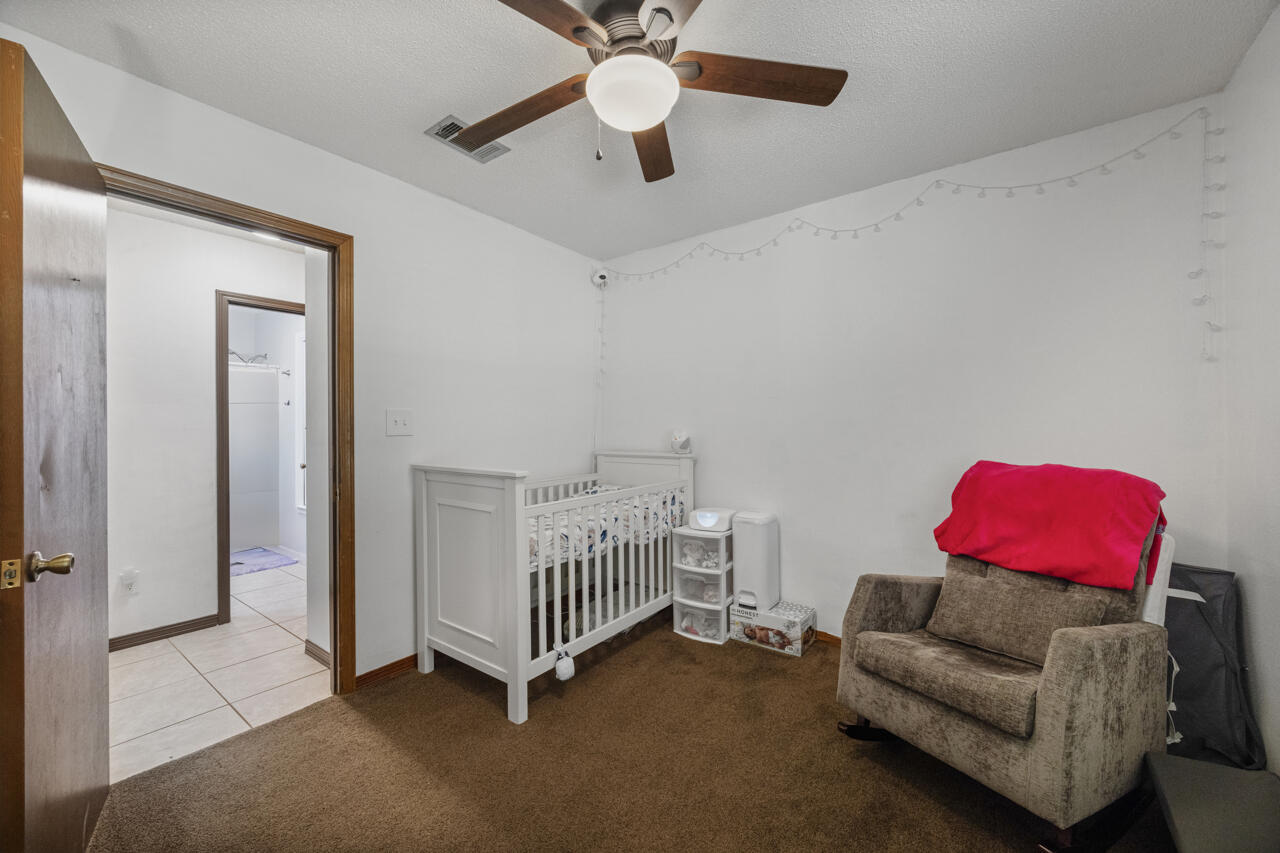 7151 Wallace Drive Pace, FL 32571 - Photo 24 of 40 a bedroom with furniture and a ceiling fan