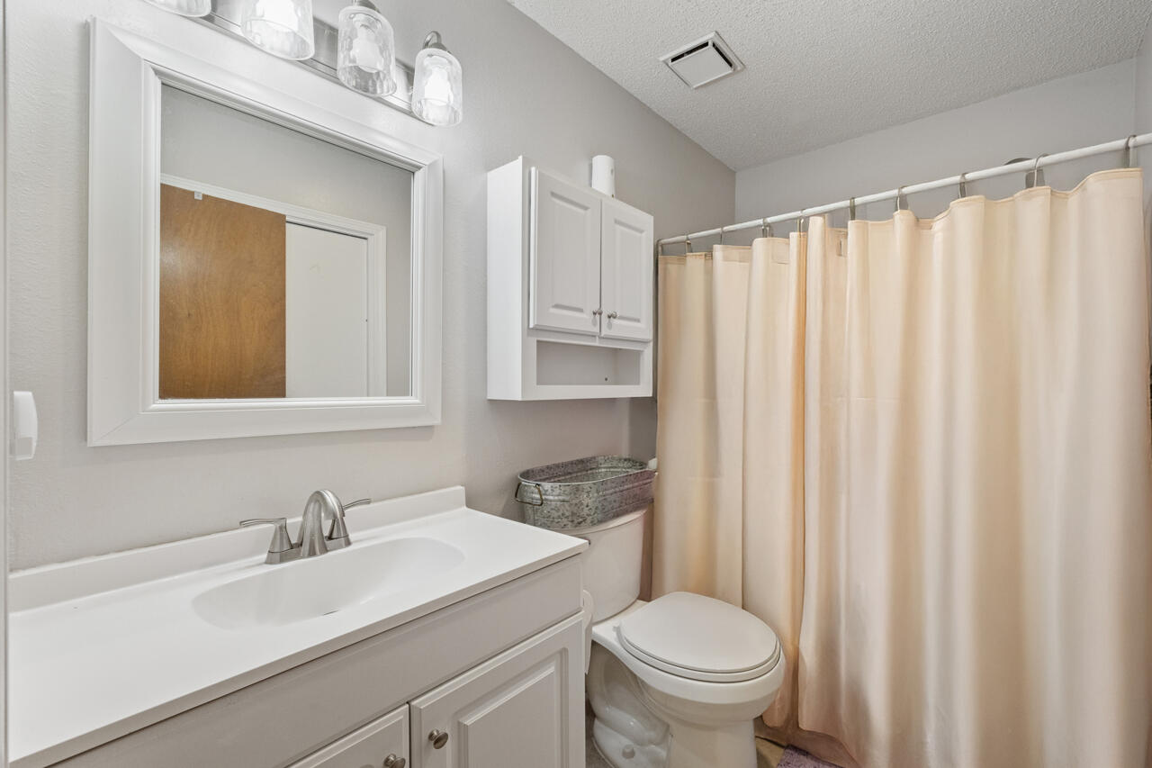 7151 Wallace Drive Pace, FL 32571 - Photo 25 of 40 a bathroom with a granite countertop sink and a mirror