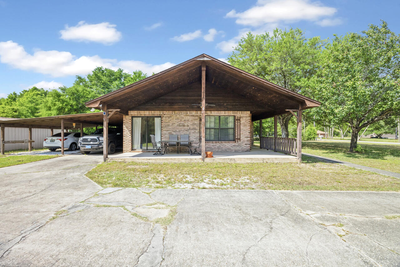 7151 Wallace Drive Pace, FL 32571 - Photo 27 of 40 a view of pool with table and chairs under an umbrella