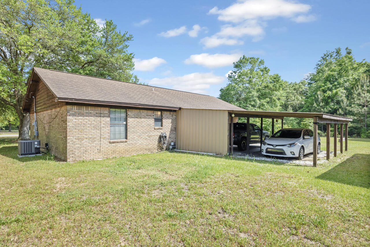 7151 Wallace Drive Pace, FL 32571 - Photo 28 of 40 a view of a house with backyard porch and sitting area