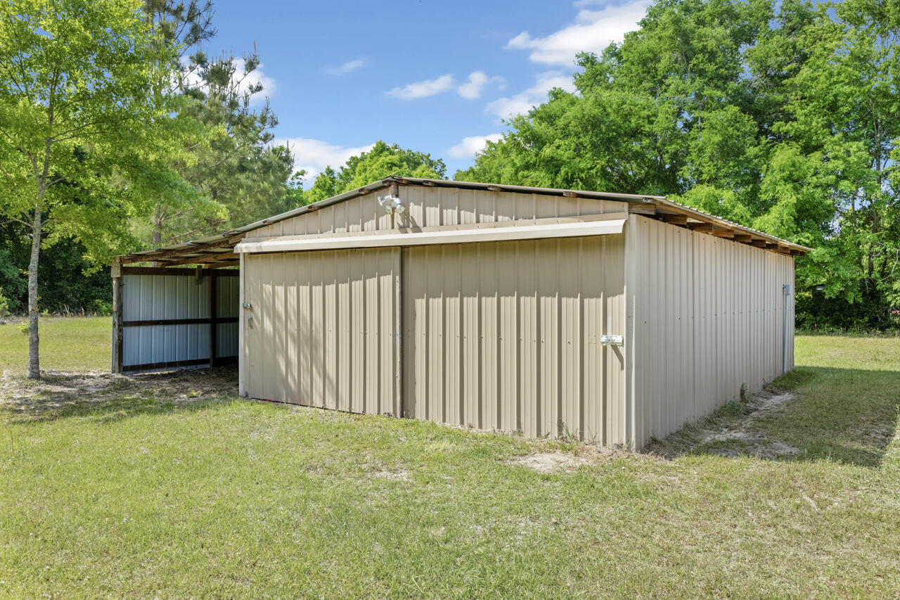 7151 Wallace Drive Pace, FL 32571 - Photo 33 of 40 a backyard of a house with lots of green space