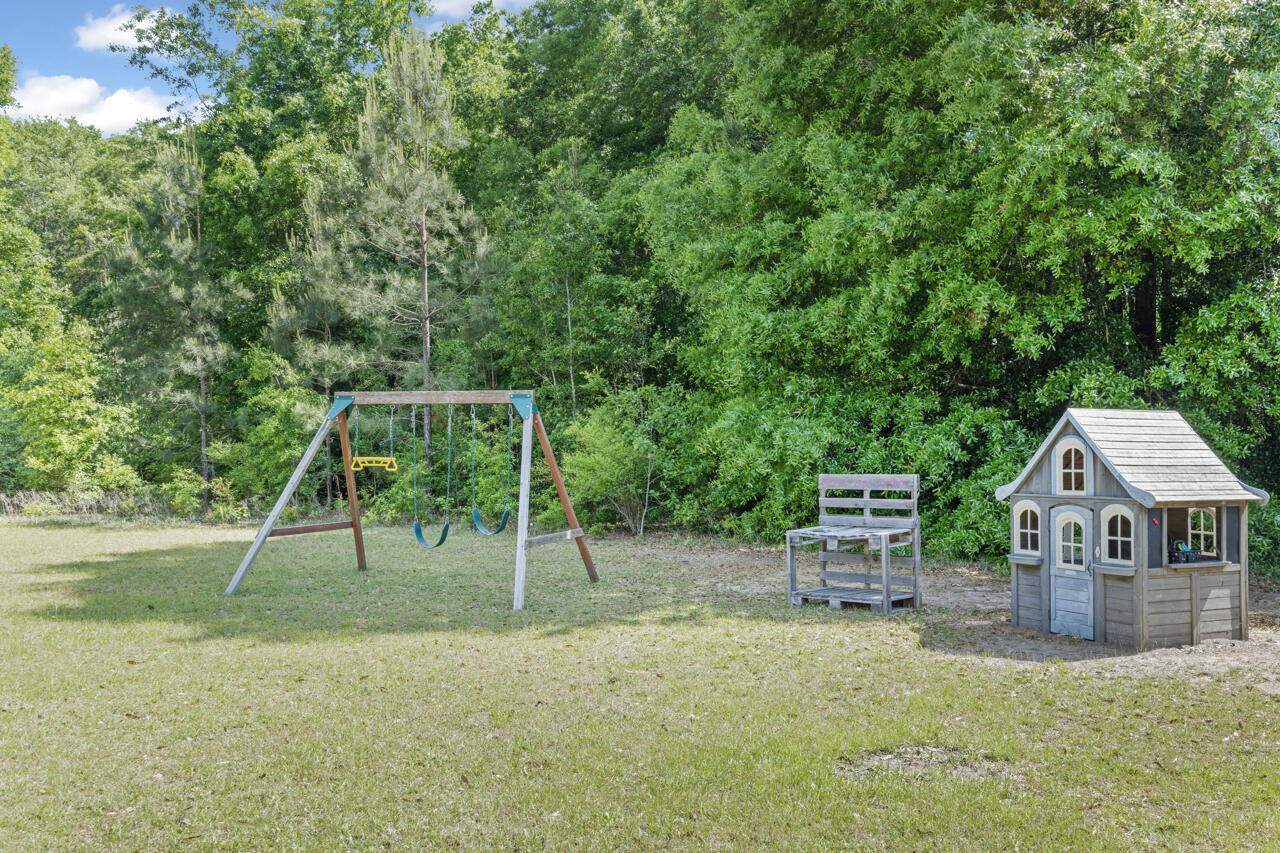 7151 Wallace Drive Pace, FL 32571 - Photo 34 of 40 a view of a house with a yard