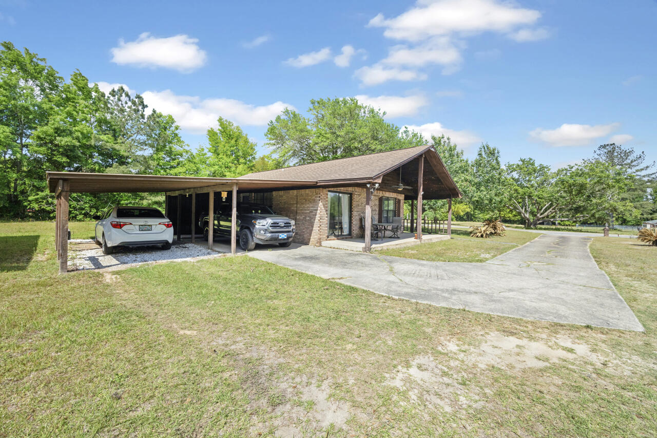 7151 Wallace Drive Pace, FL 32571 - Photo 4 of 40 a view of a house with swimming pool and a yard