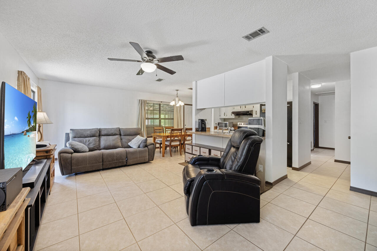 7151 Wallace Drive Pace, FL 32571 - Photo 6 of 40 a living room with furniture and a flat screen tv