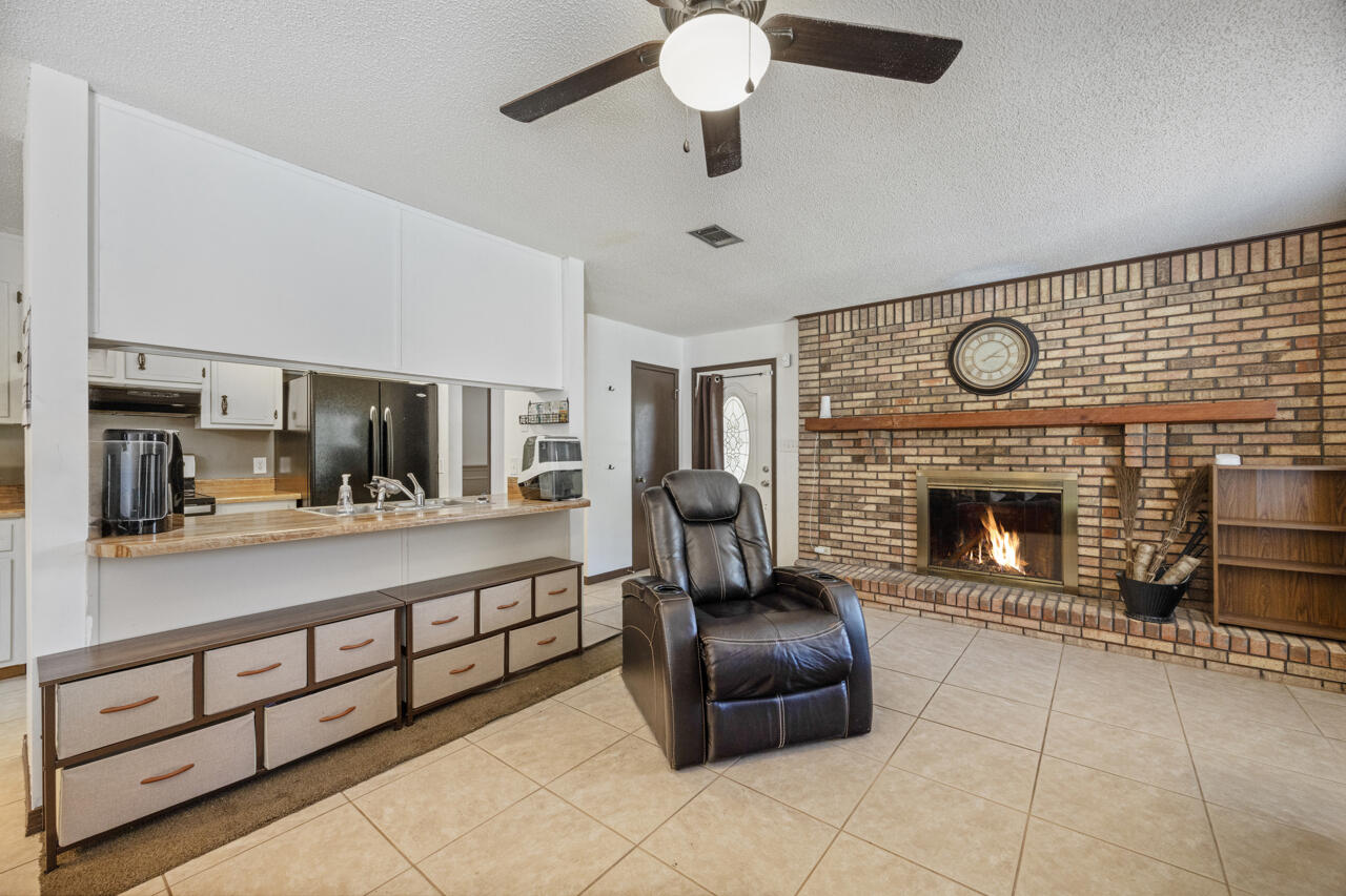 7151 Wallace Drive Pace, FL 32571 - Photo 8 of 40 a living room with furniture and a fireplace