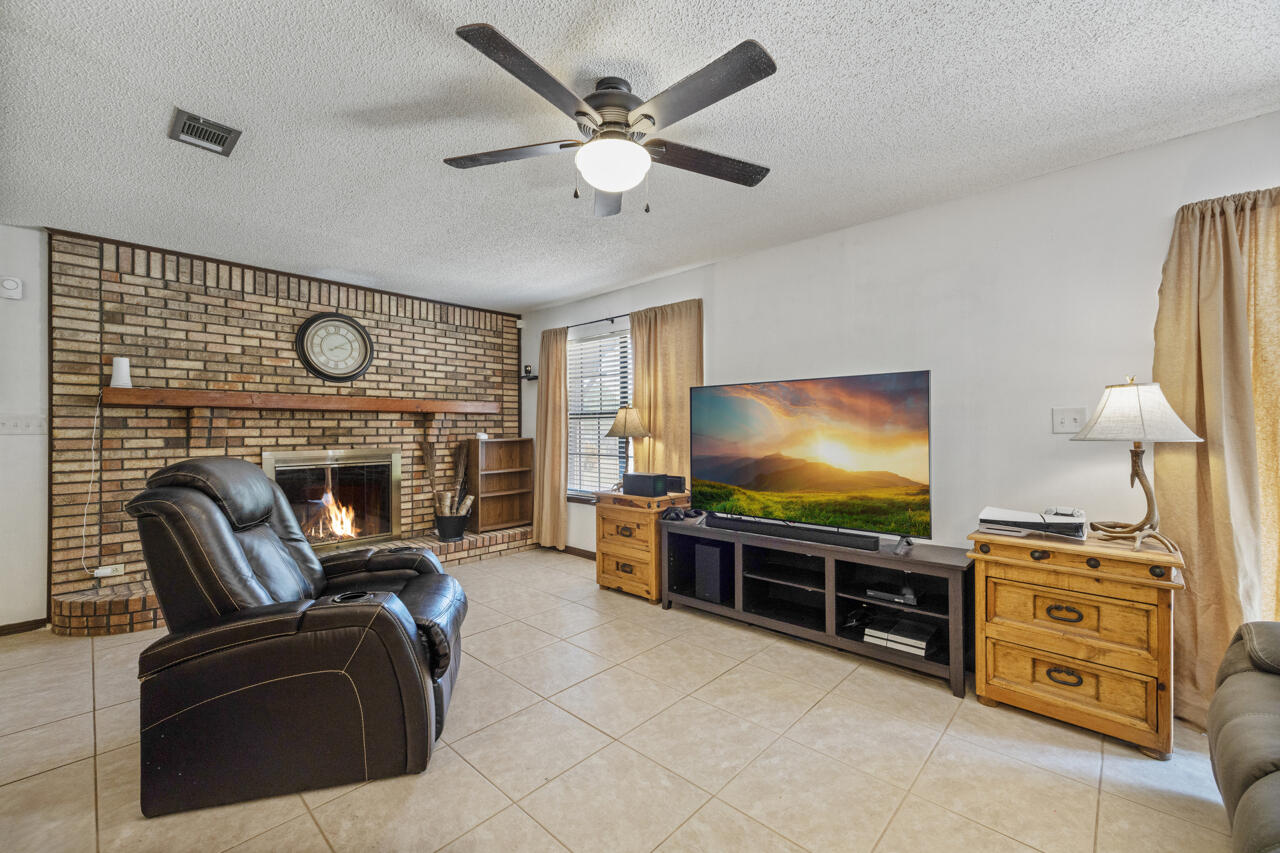 7151 Wallace Drive Pace, FL 32571 - Photo 9 of 40 a living room with furniture and a flat screen tv