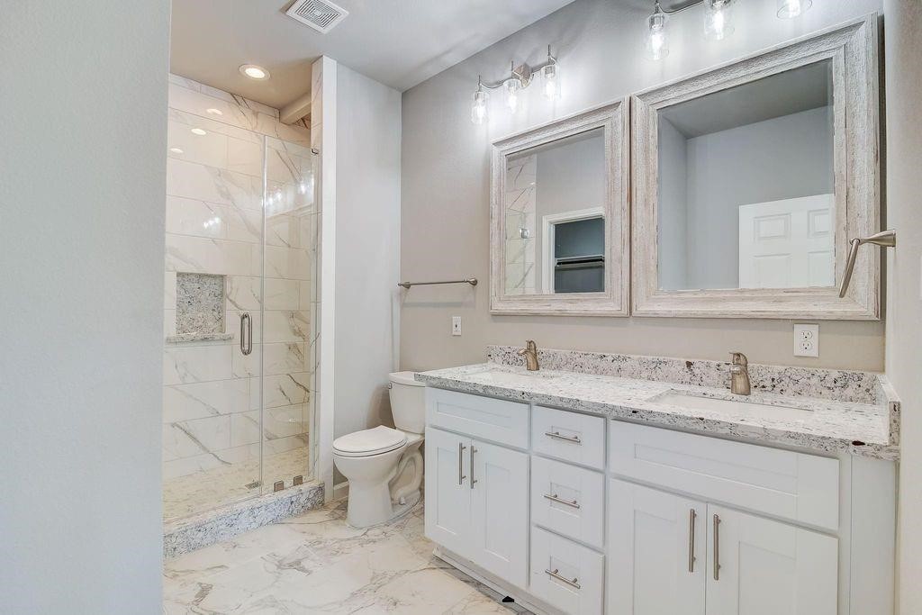 5338 Rapido Road Houston, TX 77033 - Photo 6 of 9 a bathroom with a toilet sink and mirror