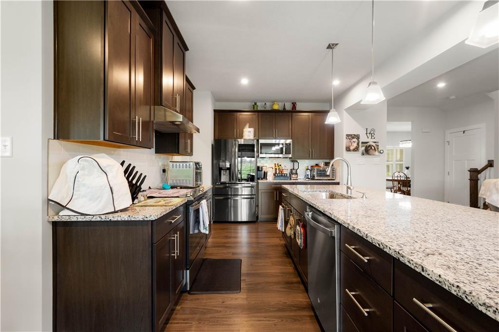254 Regency Drive Eighty Four, PA 15330 - Photo 10 of 44 Granite countertops and dark wood cabinetry shine in this stunning kitchen.