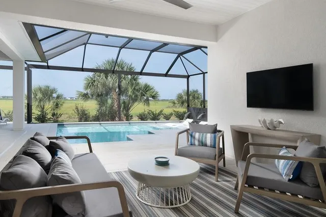 a outdoor living space with furniture and a flat screen tv