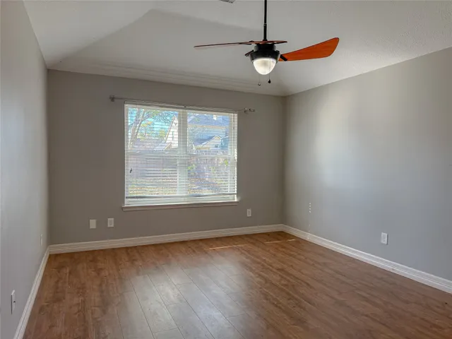 a view of a room with wooden floor