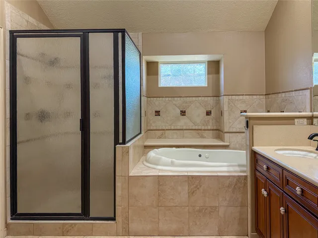 a large bathroom with a double vanity sink a large mirror and a shower