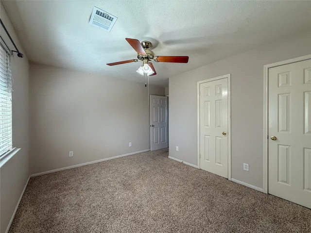 a bathroom with a granite countertop sink a large mirror and a toilet