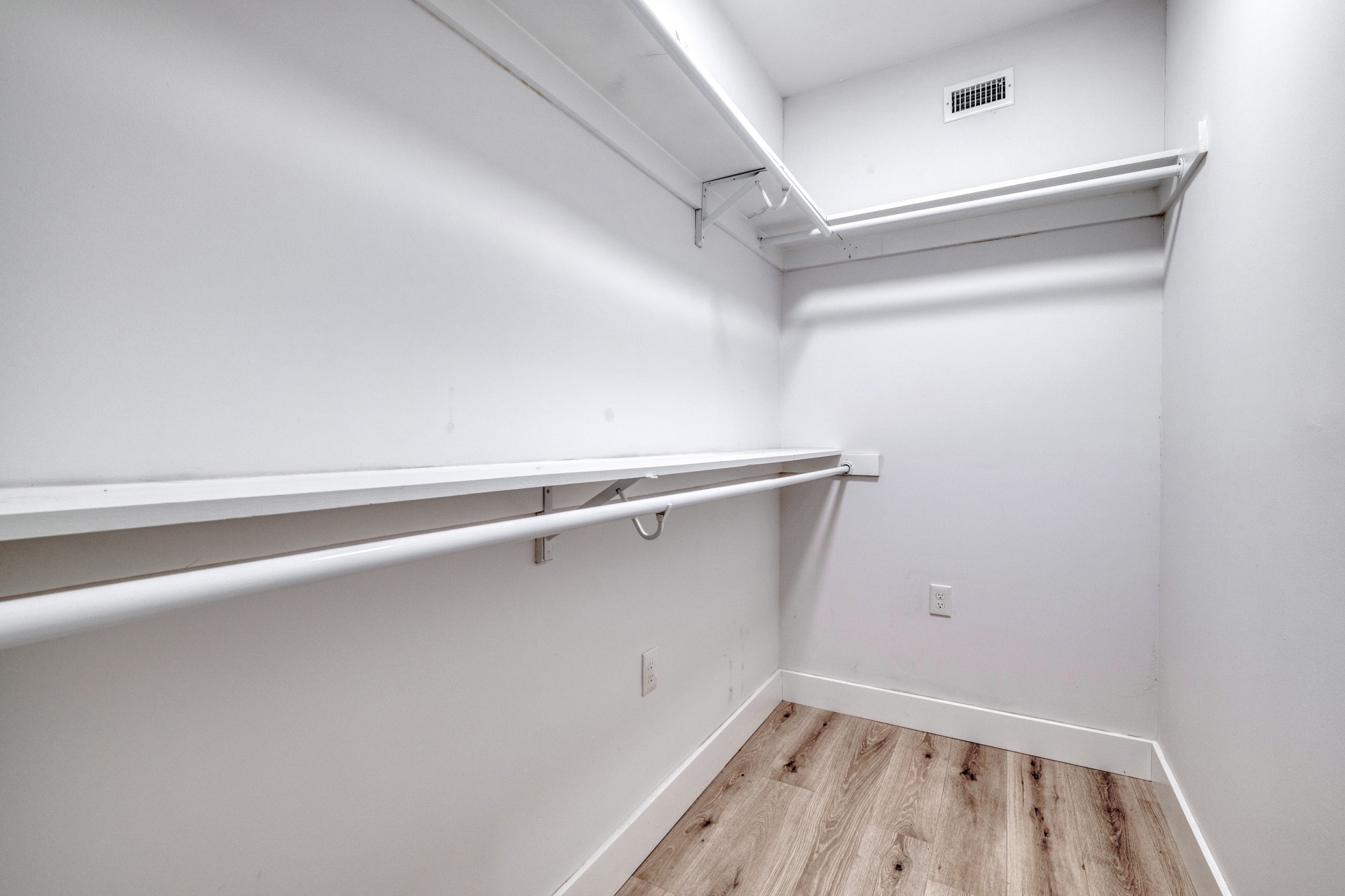 5211 Rob-Scott Street Austin, TX 78721 - Photo 17 of 24 A well-organized walk-in closet offers ample storage space and durable flooring.