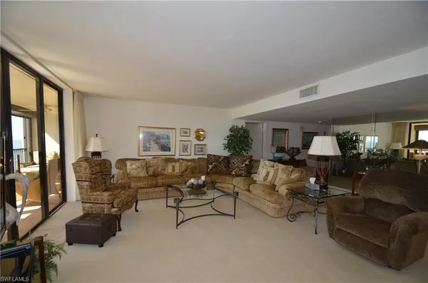 a living room with furniture and a lamp