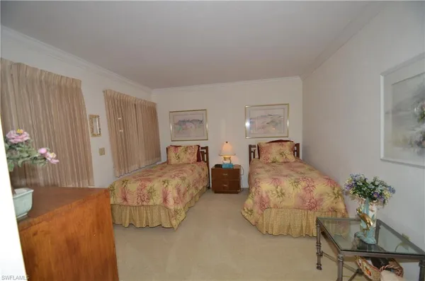 a bedroom with bed and a potted plant