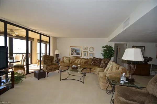 a living room with furniture and a lamp
