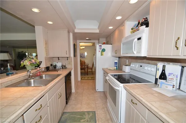 a kitchen with a sink stove and cabinets