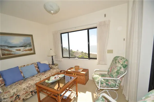 a living room with furniture and large windows