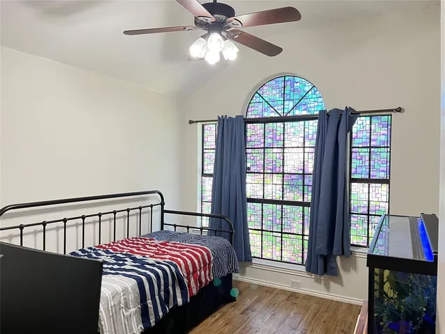 a bedroom with a bed and a chandelier
