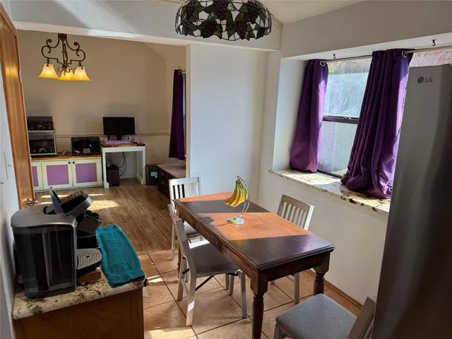 a view of a workspace with furniture and a flat screen tv