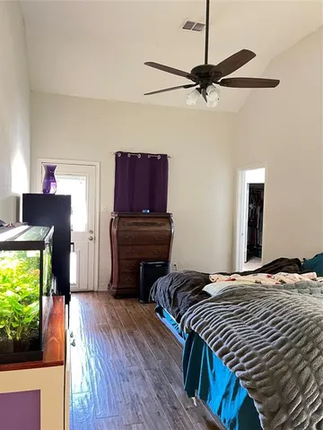 a bedroom with a bed and a television