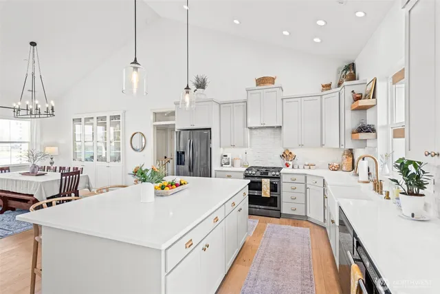 a large white kitchen with a large window