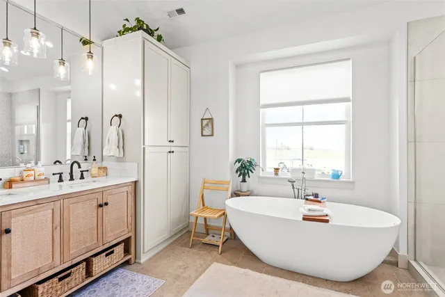 a bathroom with a tub sink and mirror