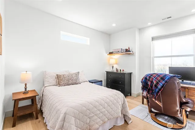 a bedroom with a bed and a chair