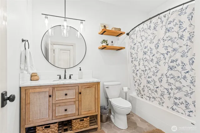 a bathroom with a toilet a sink and a mirror