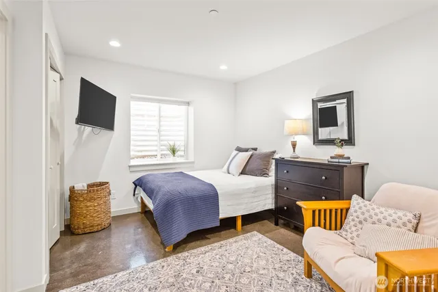 a bedroom with a bed and a couch