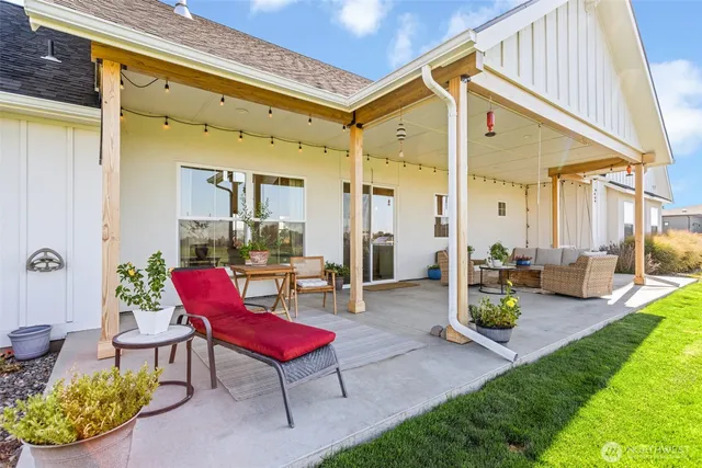 a view of a patio with dining table and chairs