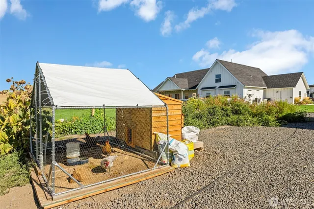 a view of a house with backyard porch and sitting area