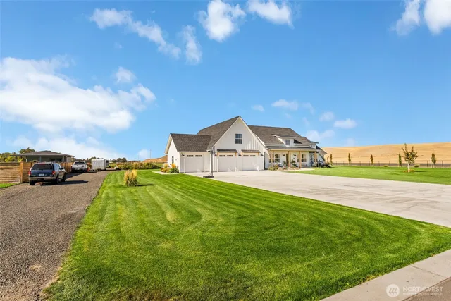 a view of green field with house in the background