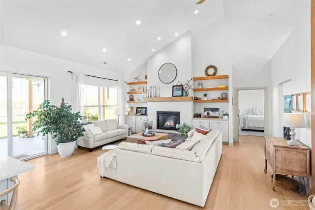 a living room with furniture fireplace and a large window