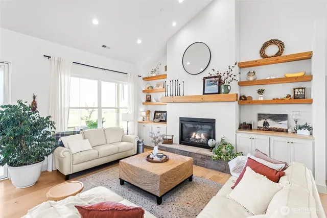 a living room with furniture a rug and a fireplace
