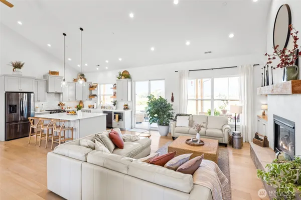 a living room with fireplace furniture and a large window