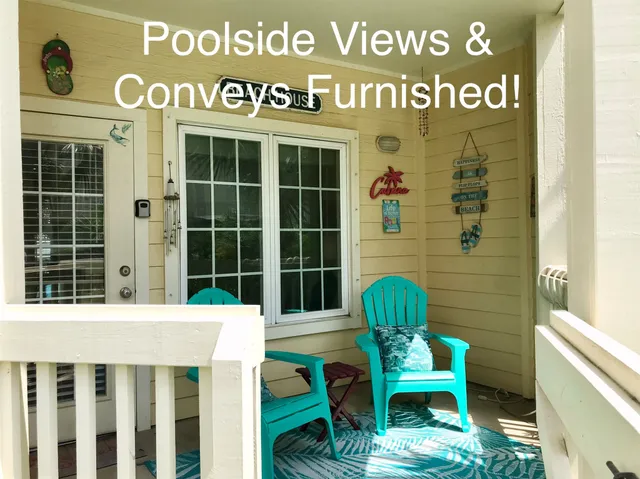 a front view of a building with garden and seating area