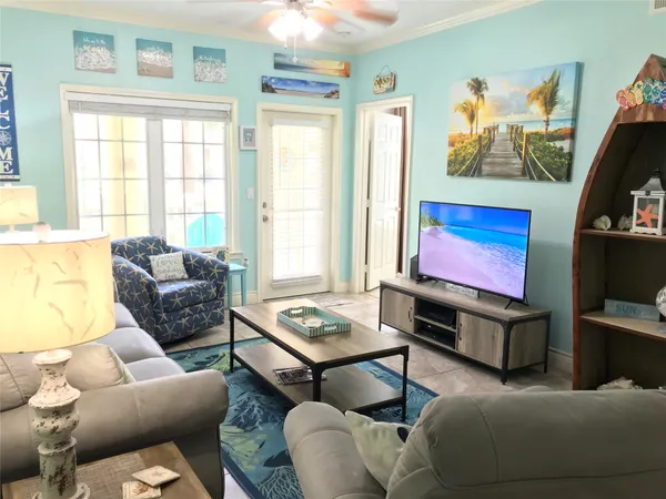 a living room with furniture and a flat screen tv