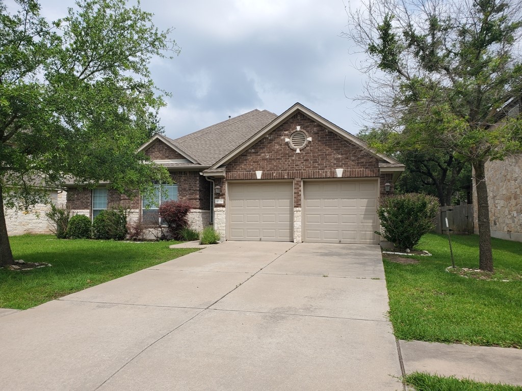 a front view of a house with a yard and garage