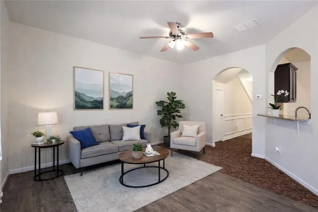 a living room with furniture and wooden floor