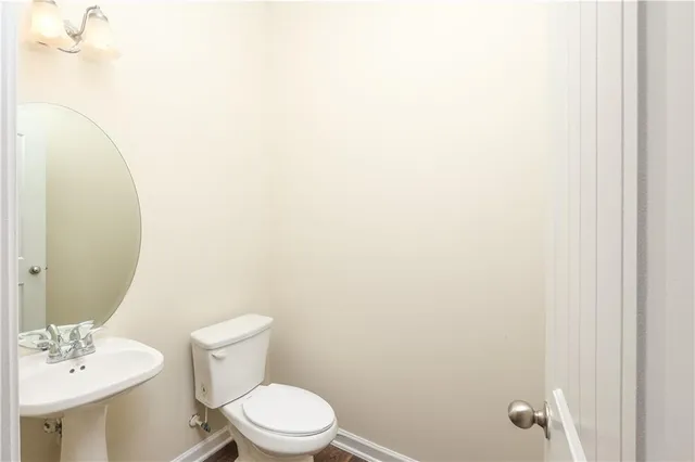 a white toilet sitting next to a bathroom sink