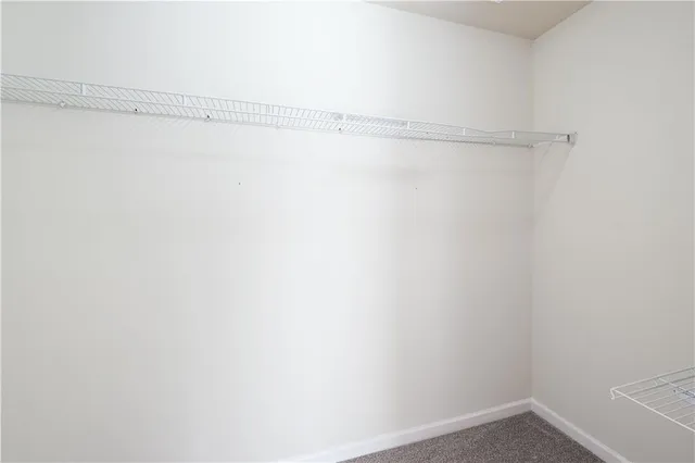 an empty room with a ceiling fan and a window